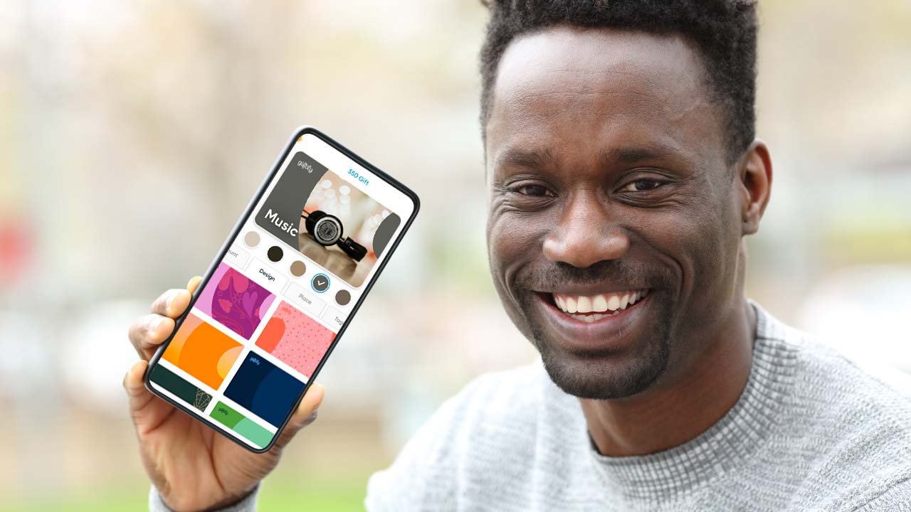 man holding phone with giftly website