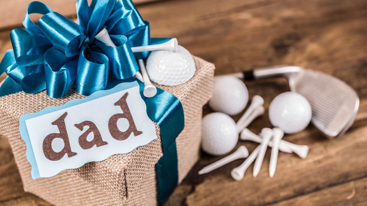 wrapped box that says "dad" and golf tees