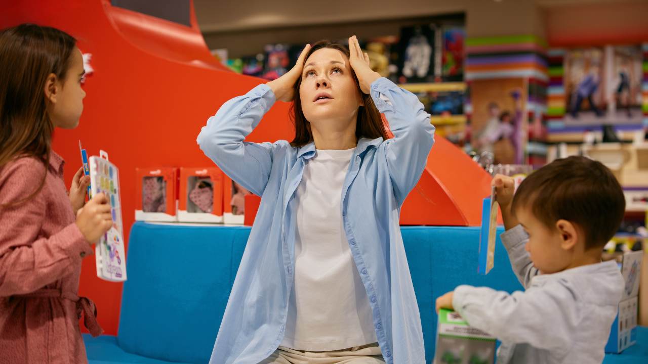 stressed mom shopping with two kids